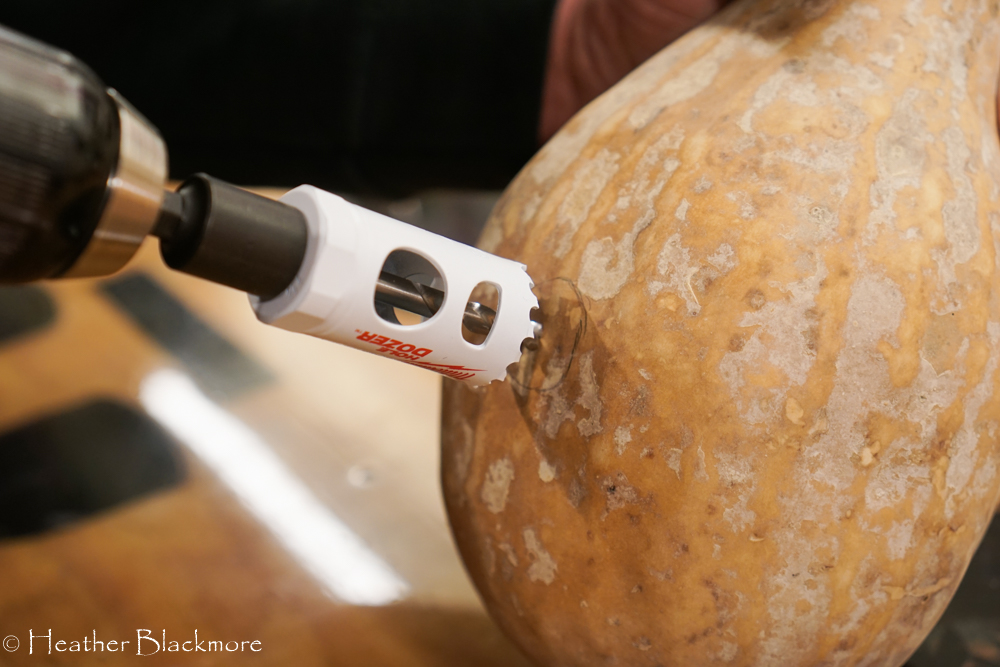 Drilling a hole in the gourd